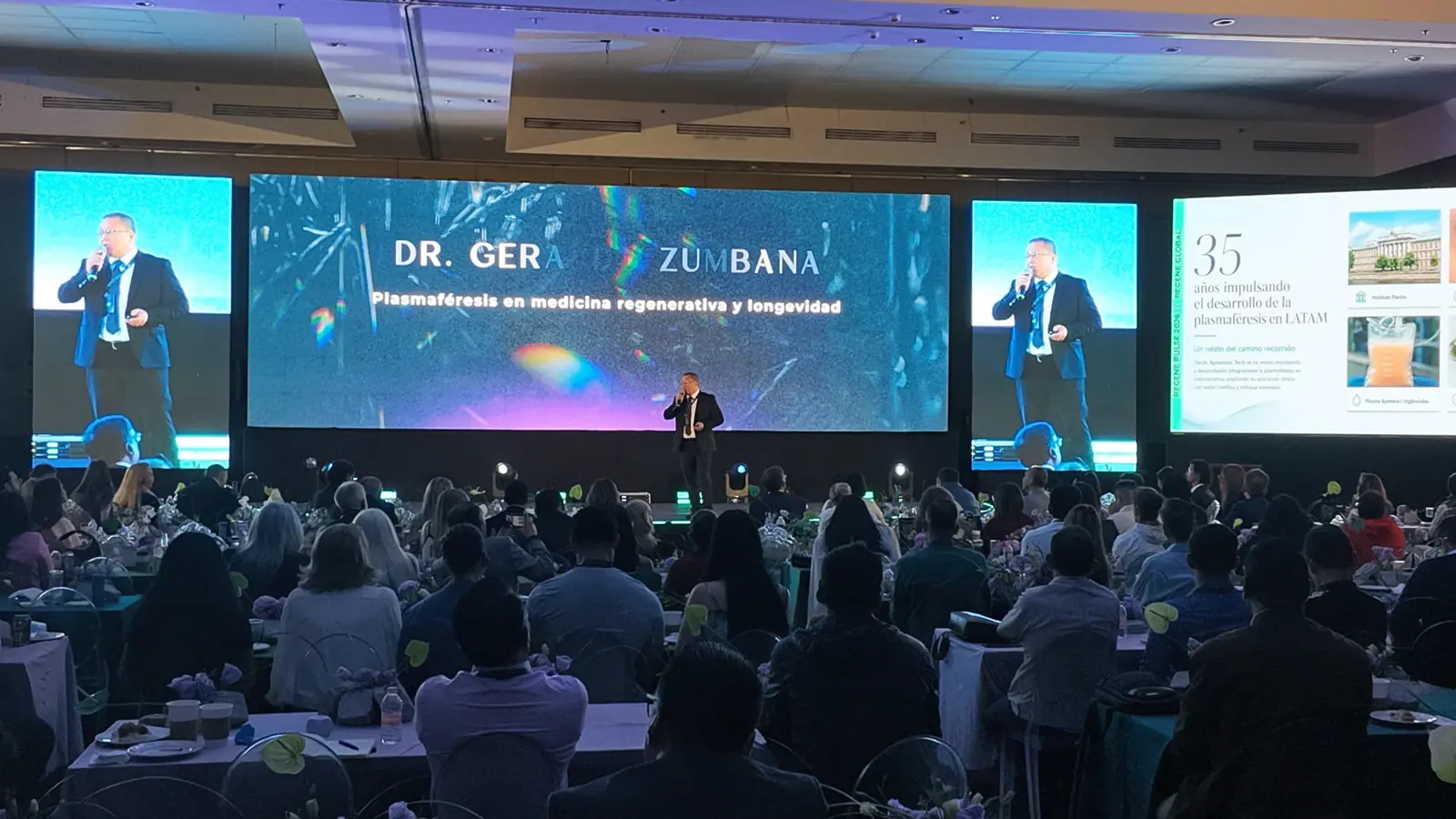 Dr. Gerardo Zumbana presenting on stage at an international regenerative medicine congress